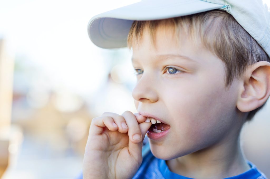 Boy with loose tooth