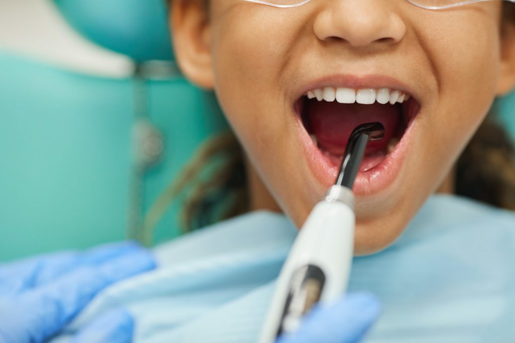 Patient treating her teeth